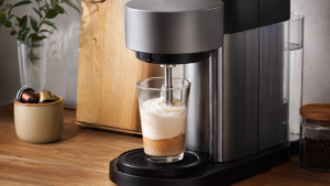 Nespresso Atelier review showing the in-cup milk frother creating creamy foam directly inside a glass
